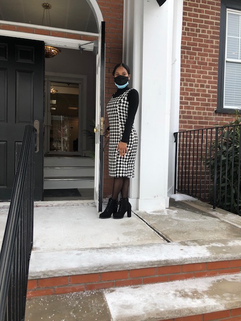 Staff member standing by front door